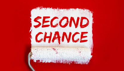 SECOND CHANCE .One open can of paint with white brush on red background. Top view.