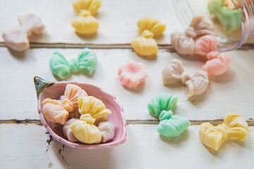 High angle views Allure Thai candy in a mini bowl on a white wooden table, Allure is traditional Thai desserts sweet and delicious.