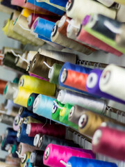 Fototapeta na wymiar Colorful thread spools used in fabric and textile industry