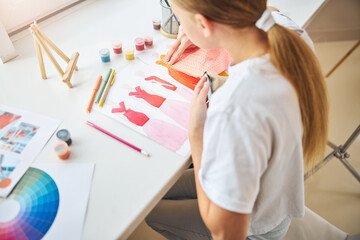 Young designer working in her home studio
