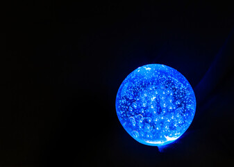 Obraz na płótnie Canvas magic ball glowing blue on a dark background