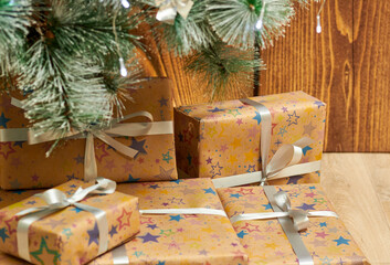 Christmas tree with colorful balloons and gift boxes on a wooden background