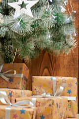 Christmas tree with colorful balloons and gift boxes on a wooden background