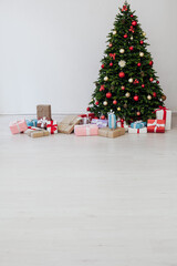 beautiful Christmas tree with gifts decor new year and terrier white room
