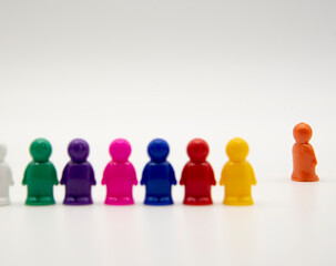 Board game colorful plastic figures stand on a white background, one man in the distance.