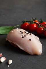 Raw chicken fillet on a concrete table with spices. 