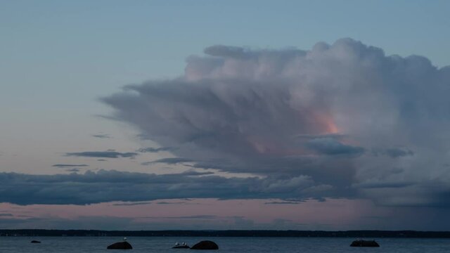 Time lapse video of color  and form changing clouds over a fjord  at sunset. Southern Norway