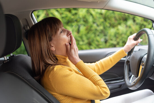 Tired Woman Yawning In Car