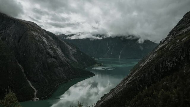 Time lapse video of beautiful Eidfjord in Western Norway.  Shadows of clouds moving over green water of the fjord