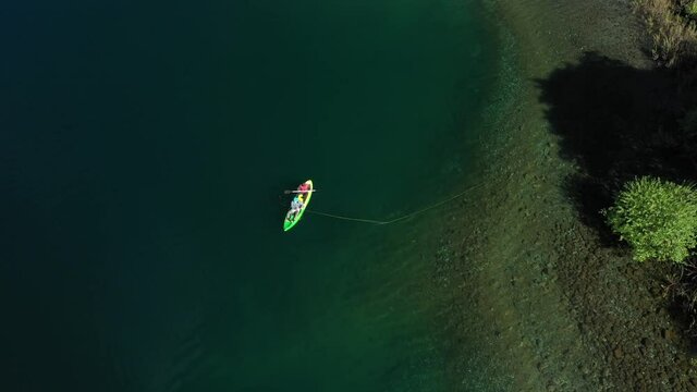 Aerial top down of two experienced dry fly fishers in a kayak close to shore in Lake Steffen, Patagonia Argentina.