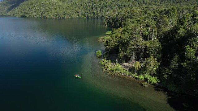Dolly in of a couple of proffesional dry fly fishers in a kayak catching trouts in Lake Steffen, Patagonia Argentina.