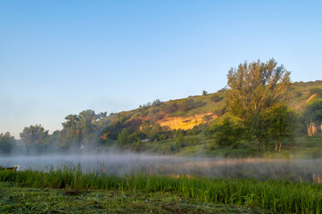 In a river landscape with nature morning with fog