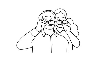 Man and woman looking at something through glasses.