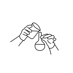 Human hands pours liquid from one flask in another.