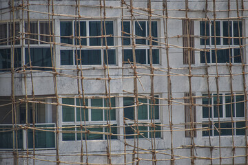 bamboo scaffolding on building ,construction site . Bamboo tied with jute ropes