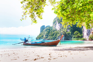 Fototapeta na wymiar Long tail boat park on the beach with have turquoise sea blue sky at Koh Hong lagoon,Krabi south of Thailand.