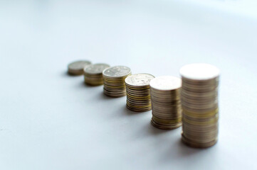 Increasing columns of coins, looks like as growth chart, step of stacks coin isolated on white background with copy space for business and financial concept idea.