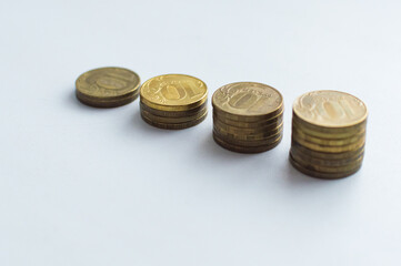 Increasing columns of coins, looks like as growth chart, step of stacks coin isolated on white background with copy space for business and financial concept idea.