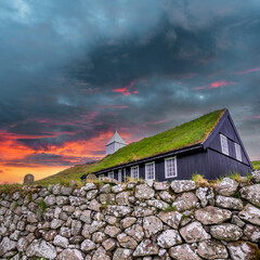 Nordic church and graveyard under dramatic sky