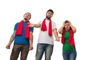 Obraz premium Shocked. Female and male soccer fans cheering for favourite sport team with bright emotions isolated on white studio background. Looking excited, supporting. Concept of sport, fun, support.