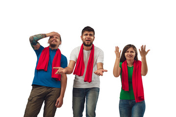 Obraz premium Shocked. Female and male soccer fans cheering for favourite sport team with bright emotions isolated on white studio background. Looking excited, supporting. Concept of sport, fun, support.