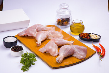 Raw whole chicken leg_white board