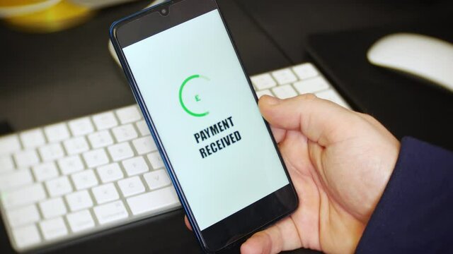 A payment received notification is received on a payment app on a cell phone. The mobile application displays an English pound sign to represent money being received.