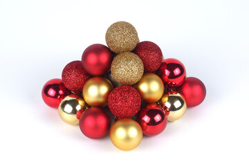 Pyramid from a red and gold christmas balls close up view on white background