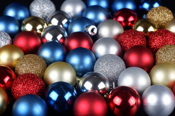 Multicolored shiny and matte christmas balls close up view background
