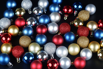 Heap of multicolored shiny and matte christmas balls close up view background