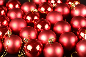 Red shiny and matte christmas balls close up view background