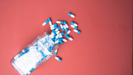 white and blue pills on red background