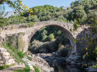 Fototapeta na wymiar Roman bridge over the Alardos gorge river. Madrigal de la Vera, Caceres, Extremadura, Spain