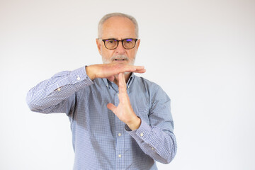 Grey haired senior man wearing casual casual shirt standing over white background Doing time out...