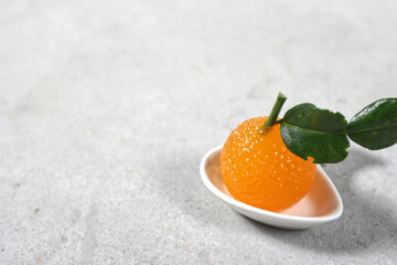 Orange jelly formed orange on a white plate.