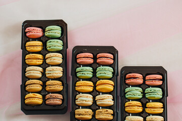3 brown boxes with macarons in different colors