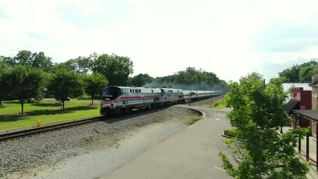 Amtrak train passing through small town in Alabama