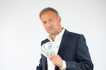 Business man holding money over white background