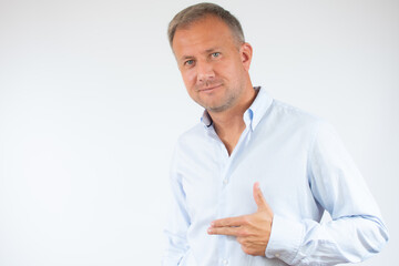 Man in casual shirt pointing space over white background