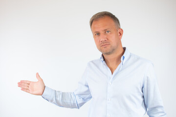 Man in casual shirt pointing space over white background