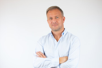 Handsome young business man with arms crossed on white background