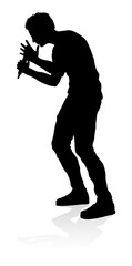 A singer pop, country music, rock star or hiphop rapper artist vocalist singing in silhouette