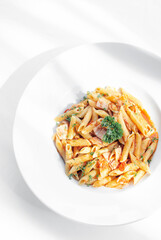 penne amatriciana tomato and ham sauce pasta on white table