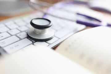 Stethoscope keyboard and diary on the table. - obrazy, fototapety, plakaty