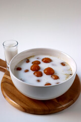 Biji Salak or Candil Ubi, Indonesian porridge with sweet potato glutinous rice balls, served with palm sugar sauce & coconut milk. An Indonesian typical refreshment and dessert during Ramadan month.