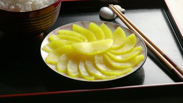 Japanese crunchy pickled daikon and slices close up as a side dish