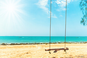 Swing on sand beach at tropical island. Tropical nature landscape