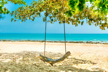 Swing on sand beach at tropical island. Tropical nature landscape