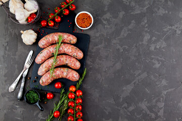 grilled sausages with spices and rosemary in a black background with copy space for text - 396757038