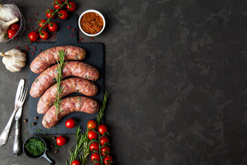 raw sausages with ingredients  in a black background with copy space for text - 396757070